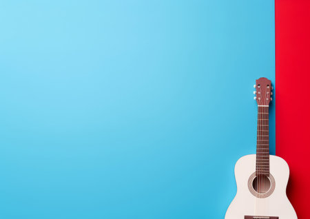 A white acoustic guitar leaning against a red and blue wallの素材