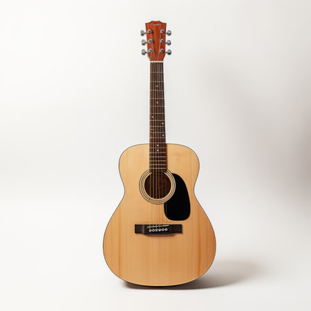 A wooden guitar sitting on top of a white surfaceの素材
