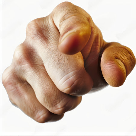 A detailed view of a person clenched fist, with knuckles prominently visible, against a plain white backdrop. The hand appears tense, suggesting strength or determination.の素材