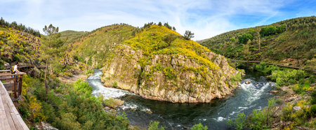 Arouca, Portugal - April 28, 2019: Panoramic landscape of a curved section of the Paiva river, seen...