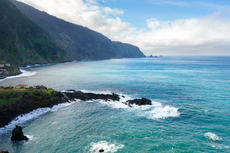 Beautiful black rock beach in Seixal, Madeira with waves crashingの写真素材