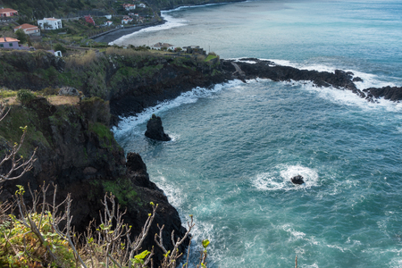 Beautiful black rock beach in Seixal, Madeira with waves crashingの写真素材