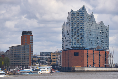 Elbphilharmonie concert hall in Hamburg with the boats marina on the frontの写真素材