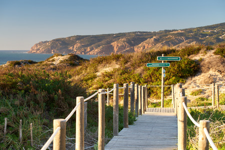 Praia do Guincho Beach pathway with indications to the beach coastline and sand dunesの写真素材