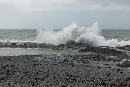 Waves crashing on a pier in Ponta do Sol, Madeiraの写真素材