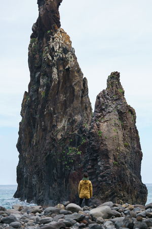 Woman looking at Ribeira da Janela islet in Madeiraの写真素材