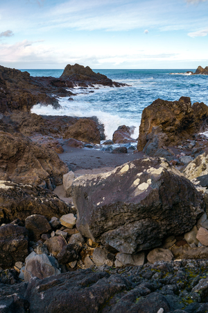 Seascape with waves crashing on the rocks in Seixal, Madeiraの写真素材
