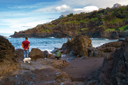 People looking at rocky beach in Seixal, Madeiraの写真素材