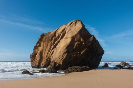 Praia de Santa Cruz beach rock boulder, in Torres Vedras, Portugalの写真素材
