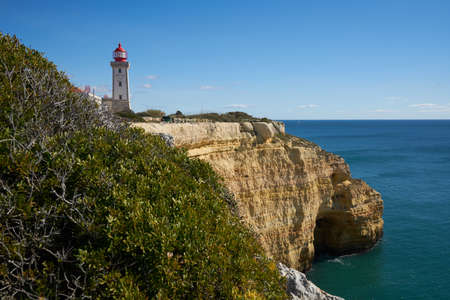 Farol de Alfanzina Lighthouse landscape in Algarve, Portugalの写真素材