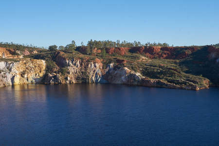 Contaminated pond lake of an old abandoned mine red landscape in Mina de Sao Domingos, Portugalの写真素材
