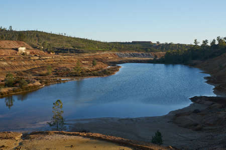 Contaminated pond lake of an old abandoned mine red landscape in Mina de Sao Domingos, Portugalの写真素材