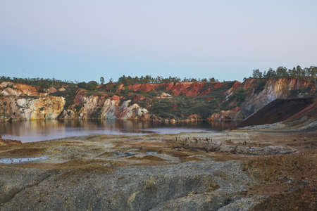 Contaminated pond lake of an old abandoned mine red landscape in Mina de Sao Domingos at sunset, Portugalの写真素材