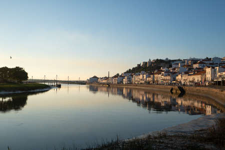 View of Alcacer do Sal cityscape from the other side of the Sado river at sunsetの写真素材