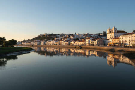 View of Alcacer do Sal cityscape from the other side of the Sado river at sunsetの写真素材