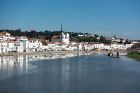 View of Alcacer do Sal cityscape from the other side and a boat on the Sado riverの写真素材