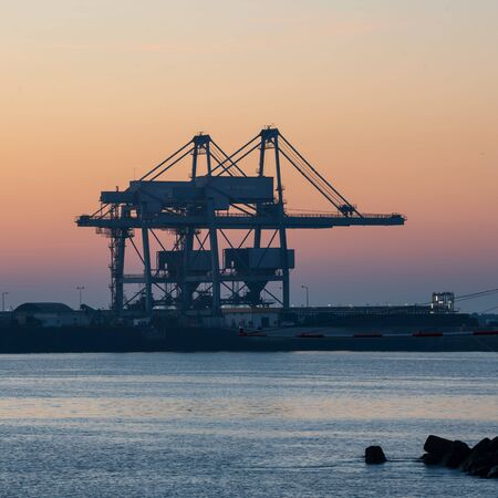Sines container port terminal with cranes at sunset, in Portugalの写真素材