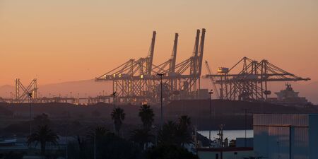 Sines container port terminal with cranes at sunset, in Portugalの写真素材