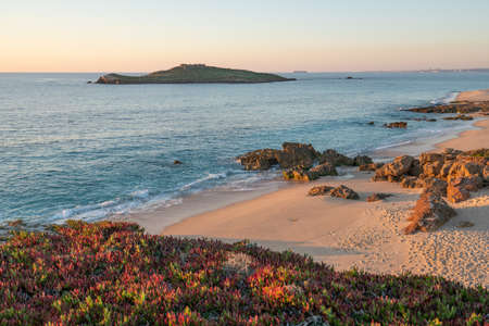 Porto Covo beach at sunset with Ilha do Pessegueiro Island on the background, in Portugalの写真素材