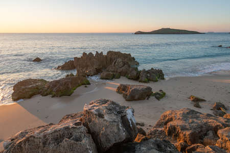 Porto Covo beach at sunset with Ilha do Pessegueiro Island on the background, in Portugalの写真素材
