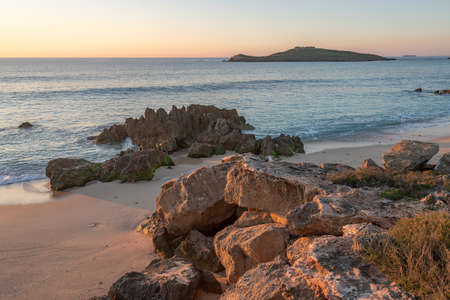 Porto Covo beach at sunset with Ilha do Pessegueiro Island on the background, in Portugalの写真素材