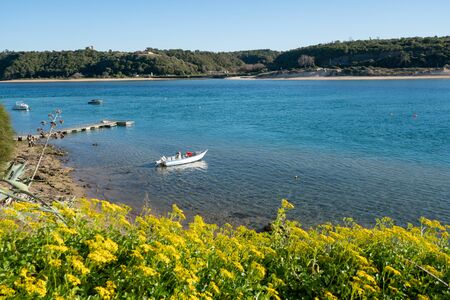 View of Vila Nova de Milfontes view of river Mira with boats, in Portugalの写真素材
