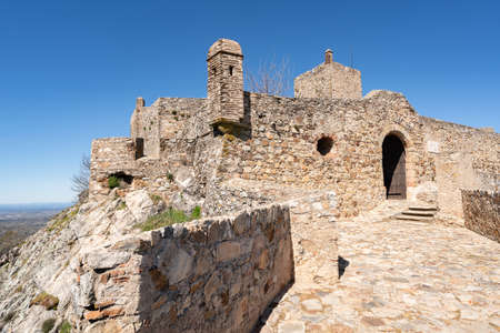 Marvao castle on the top of a mountain with beautiful green landscape behind on summer, in Portugalのeditorial素材