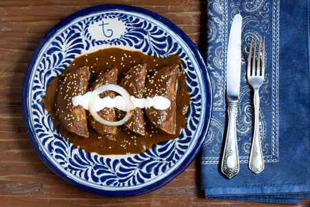 Traditional mexican food enmoladas served on talavera plateの写真素材