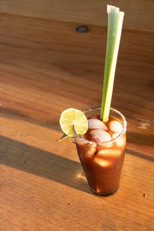 Michelada on a table on golden hourの写真素材