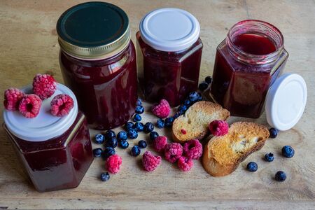 Homemade berries jam on a wooden surfaceの写真素材