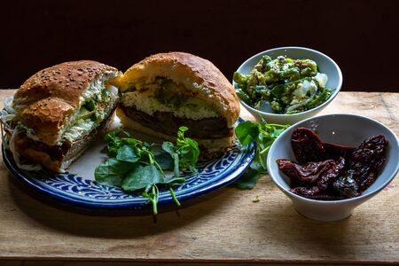 Cemita poblana served with chipotles and jalapenos with black backgroundの写真素材