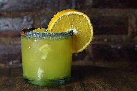 Orange and mezcal cocktail with dark brick backgroundの写真素材