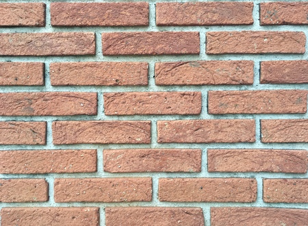 Texture of a rough wall made of red bricksの写真素材