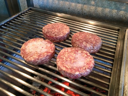 Four burgers grillingの写真素材