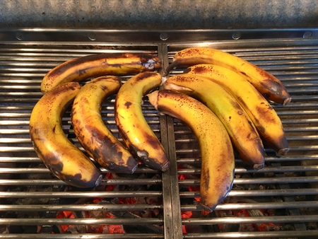 Roasted bunch of bananas on the metal grillの写真素材