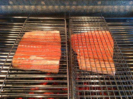 Fresh salmon pieces for preparation on the metal grillの写真素材