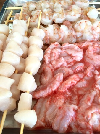 Fresh seafood on skewers, such as shrimps, crayfish and scallopsの写真素材
