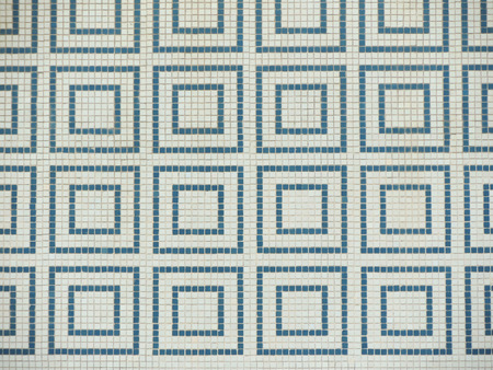 Wall clad with small colorful tiles in geometric shapes