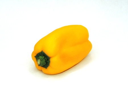 A single yellow bell pepper on white backgroundの写真素材