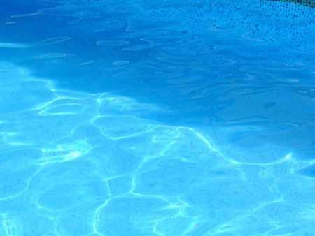 Water surface in a swimming pool with blue tilesの写真素材