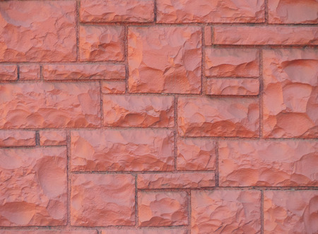 Rustic wall of rectangular blocks painted redの写真素材