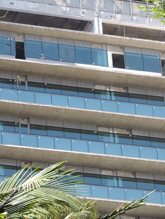 Glasses being installed on the facade of a building under constructionの写真素材