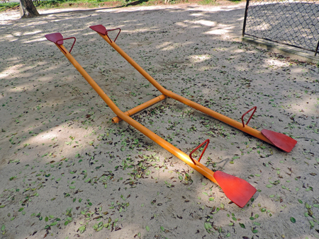 Detail of a metal seesaw in a playground