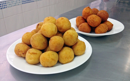 Plates with portions of fried stuffed snacks