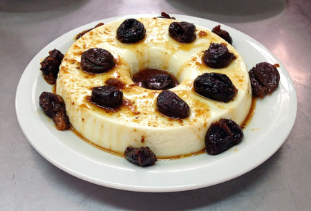A white pudding covered with plums and syrupの写真素材