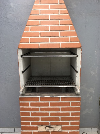 A brick barbecue in the backyard of a houseの写真素材