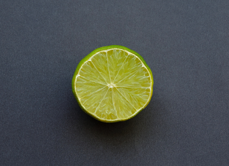 A half lemon on the dark background