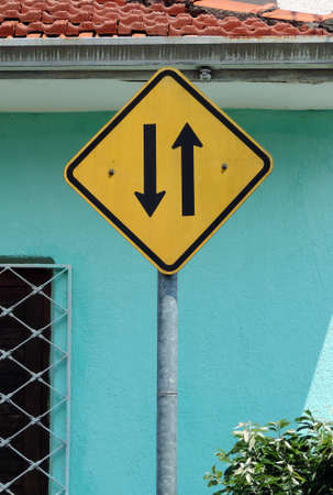 A two way traffic sign in the street