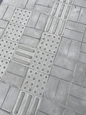 Close-up on pavement with tactile floor stripsの写真素材