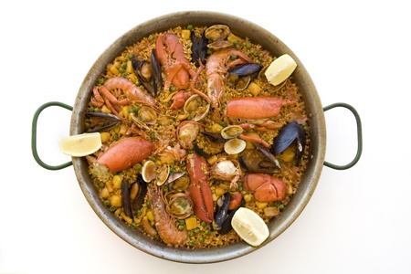 Spanish paella served on a dish with a white backgroundの写真素材